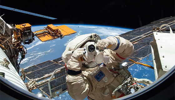 Cosmonaut Alexander Skvortsov uses a camera during a spacewalk