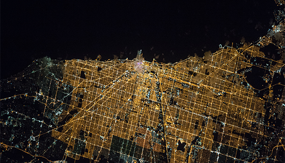 The bright lights of Chicago form a large grid along the dark coast of Lake Michigan in this picture taken from the space station