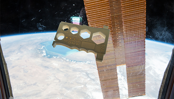 A 3-D printed tool floats inside the space station
