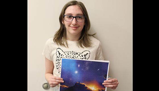 Anna Fox holds her award-winning art
