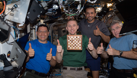 NASA astronauts Frank Rubio, Woody Hoburg, and Stephen Bowen, with UAE (United Arab Emirates) astronaut Sultan Alneyadi give "thumbs up" with their floating chess board on the space station