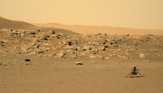 The small Ingenuity helicopter sits on the rocky surface of Mars