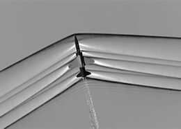 Lines streak out from an airplane as it flies at supersonic speeds