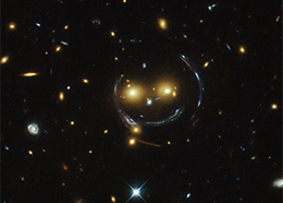 A deep space image showing galaxies that seem to form a smiling face