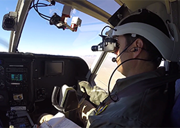 A pilot wears a Fused Reality headset during flight training