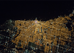 The bright lights of Chicago form a large grid along the dark coast of Lake Michigan in this picture taken from the space station