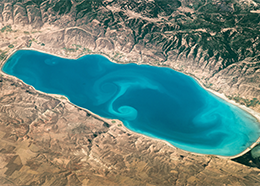 A bright blue lake with aqua-colored swirls in the center