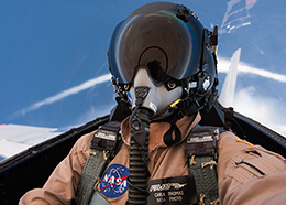 NASA photographer Carla Thomas wears a helmet and face mask during a supersonic flight
