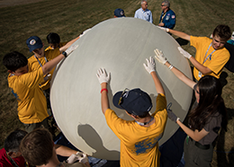 Boy Scouts outdoors preparing a weather balloon for flight