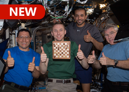 NASA astronauts Frank Rubio, Woody Hoburg, and Stephen Bowen, with UAE (United Arab Emirates) astronaut Sultan Alneyadi give "thumbs up" with their floating chess board on the space station