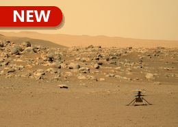 The small Ingenuity helicopter sits on the rocky surface of Mars