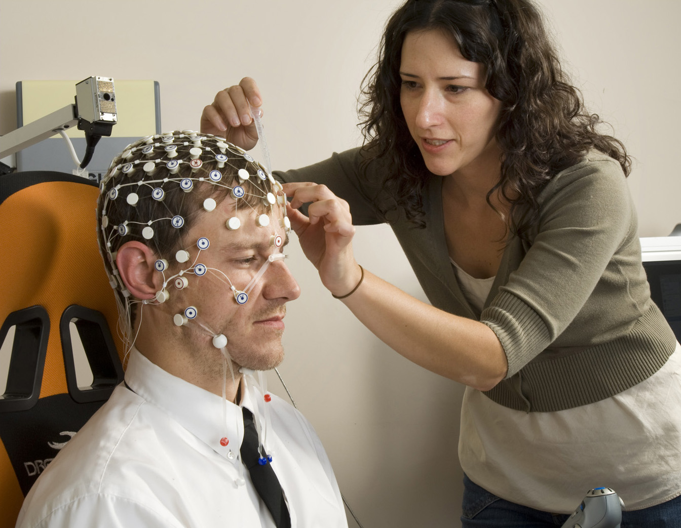 A researcher placing sensors on a pilot.