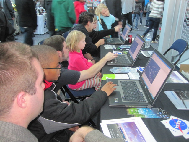 Air traffic controller Brian Hartman (left) guides students on their computers.