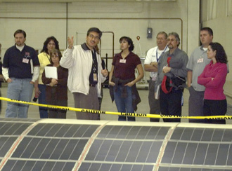 With a solar cell-covered wing section in the foreground, NASA Dryden solar aircraft project manager