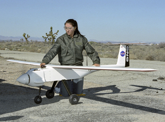 NASA Dryden Operations co-op student Shannon Kolensky holds one of the APV-3 UAVs.