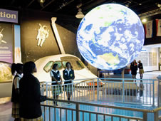 Students watch clouds shift across the globe in real time on Science on a Sphere