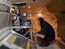 Goddard technician checks out the Laser Vegetation and Ice Imaging Sensor mounted in the belly of NASA's DC-8.