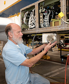 JPL's Richard Denning installs the Microwave Temperature Profiler into NASA's Global Hawk in preparation for the Global Pacific 2010 mission.