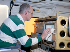 Steve Durden, Jet Propulsion Laboratory's principal investigator for the Airborne Precipitation Radar or APR-2, checks out the instrument after installation on NASA's DC-8 airborne science laboratory.