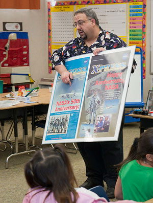 Jay Levine tells students how he designs the colorful covers of special editions newsletters.