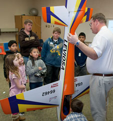 Jerry Budd shows off his competition model aircraft to students.