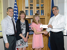 Accompanied by her parents, Michael and Jennifer Thomson, Rachel Thomson, recipient of the 2012 NASA Dryden Employee Exchange Scholarship, is congratulated by NASA Dryden Flight Research Center director David McBride.