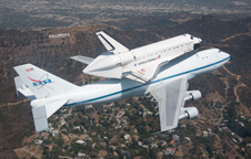 NASA Shuttle Carrier Aircraft 905 carries space shuttle Endeavour over the Hollywood Hills during the last leg of its final ferry flight into history, delivering it to the California Science Center in Los Angeles on Sept. 21, 2012.