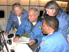 Airborne Astronomy Ambassadors Constance Gartner, Vince Washington, Ira Hardin and Chelen Johnson at the educators' work station aboard the SOFIA observatory during a flight on the night of Feb. 12-13, 2013.