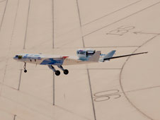 The X-48C Hybrid Wing Body research aircraft flies over the intersection of several runways adjacent to the compass rose on Rogers Dry Lake at Edwards Air Force Base during one of the sub-scale aircraft's final test flights on Feb. 28, 2013.