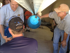 UP Aerospace personnel load one of the technology payloads into the nose of the firm's SpaceLoft 7 sounding rocket in their facility at Spaceport America in New Mexico. Seven experiments were to be carried aboard the SL7 into sub-orbital space on its June 21 launch.