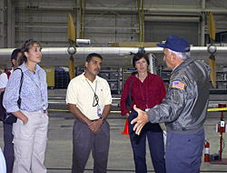 Pilot Dick Ewers describes flight research to visiting astronauts.