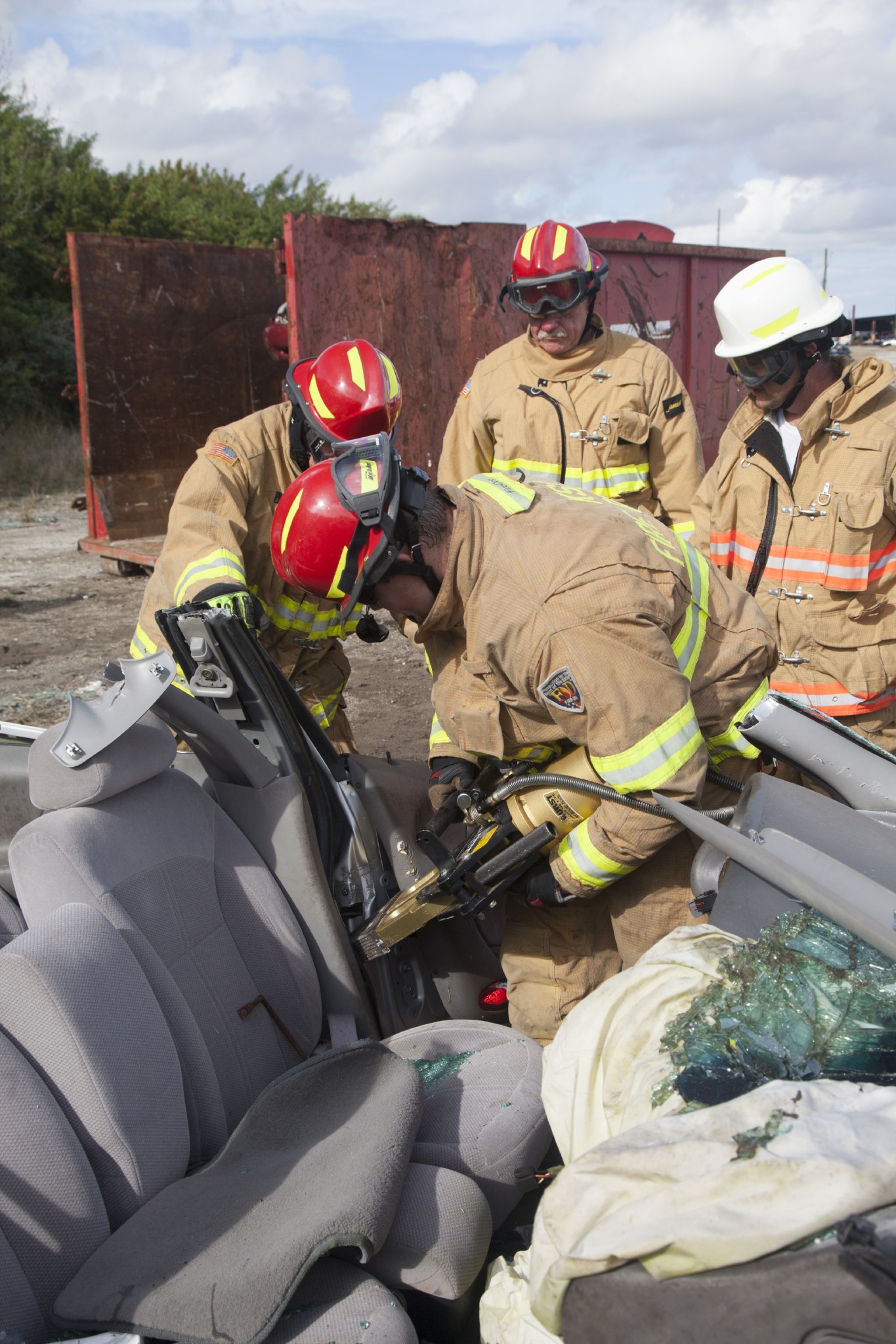 Special Rescue Operations firefighters with NASA Fire Rescue Services in the Protective Services Office at NASA's Kennedy Space Center in Florida practice vehicle extrication training at an auto salvage yard near the center. A firefighter uses the Jaws of Life to finish removing the door from the vehicle and simulate the rescue of a trapped and injured person.