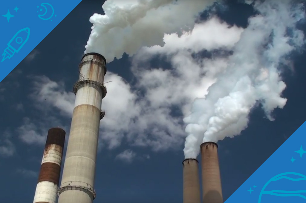 A photo of four smokestacks billowing smoke
