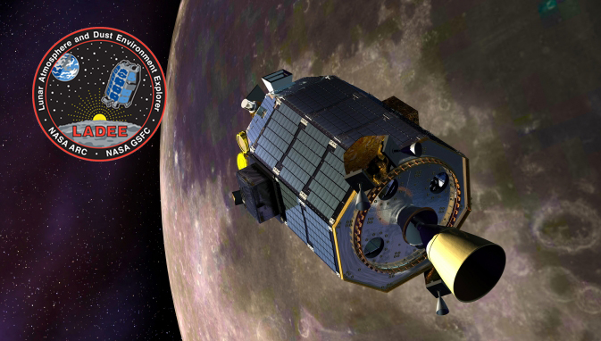 An artist concept image of NASA's Lunar Atmosphere and Dust Environment Explorer (LADEE) floating in orbit juxtaposed against a CGI Moon in the background. In the top left corner is the LADEE logo. LADEE is an octagonal tube wrapped in solar panels and technology with a motor on the end closest to the viewer.