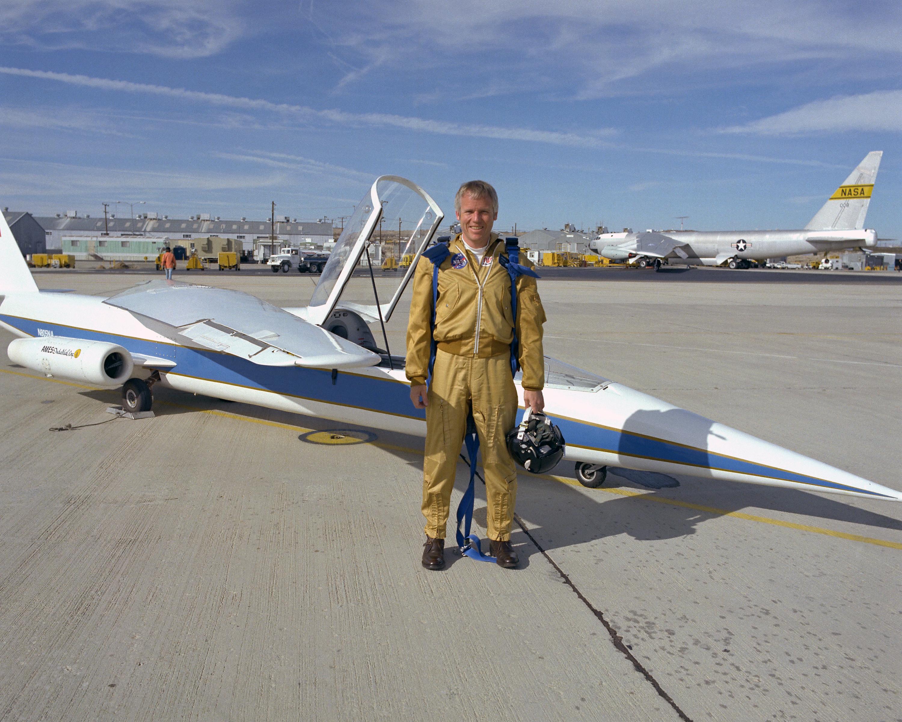 Pilot, Richard E. Gray in front of an oblique wing aircraft parked on the tarmac.