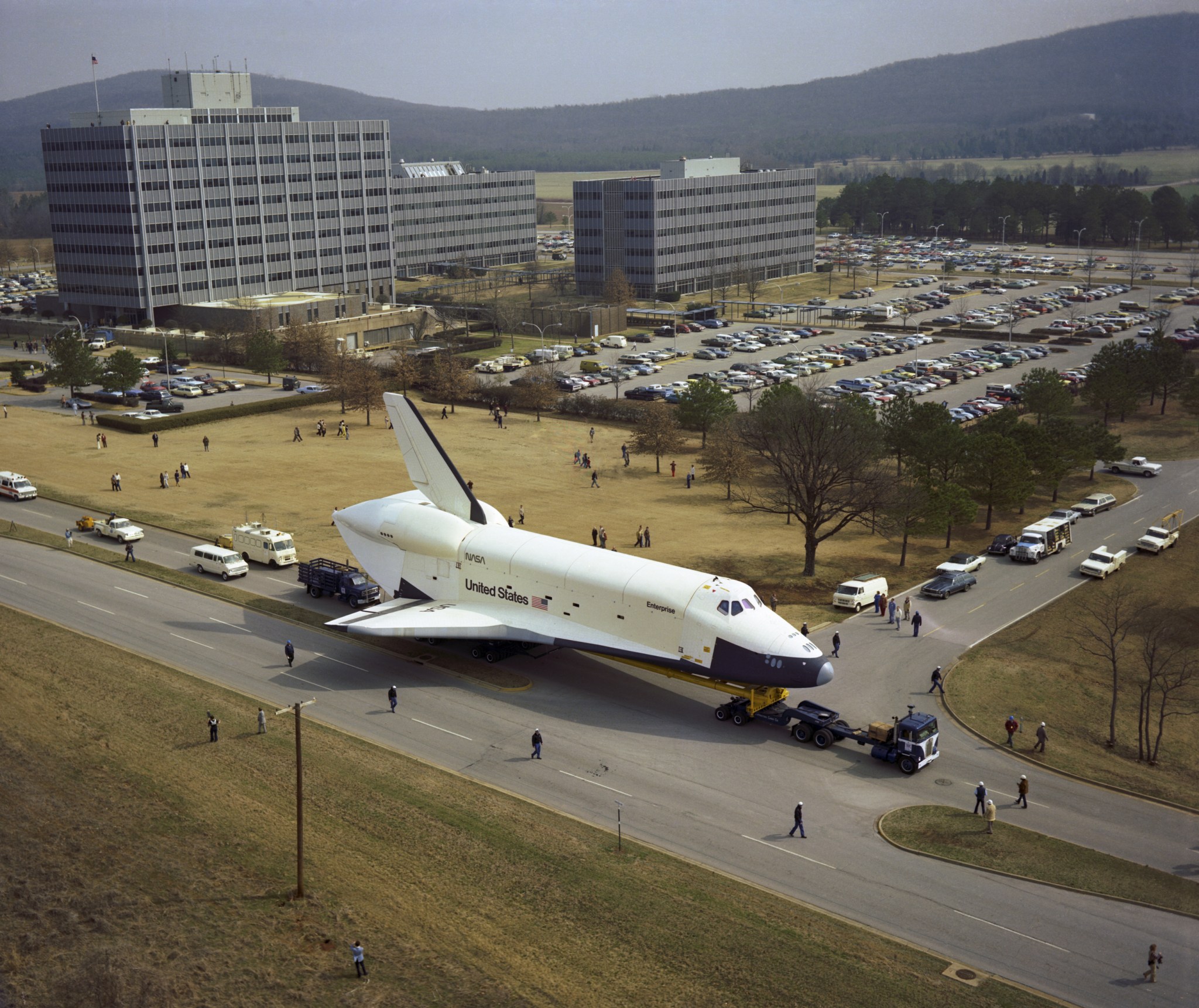 With Marshall’s administrative headquarters in the background, the Space Shuttle Enterprise heads south on Rideout Road.