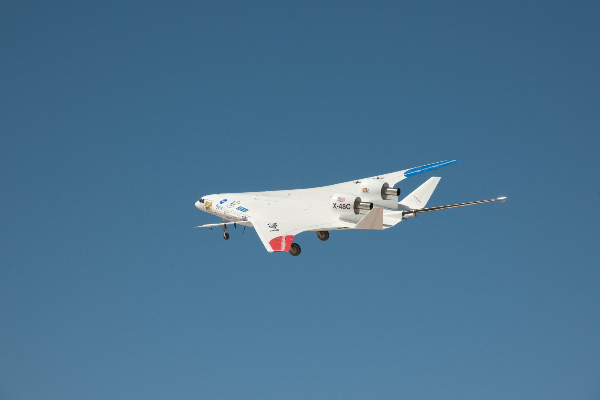 NASA-Boeing X-48C Hybrid Wing Body aircraft in flight against blue skies.