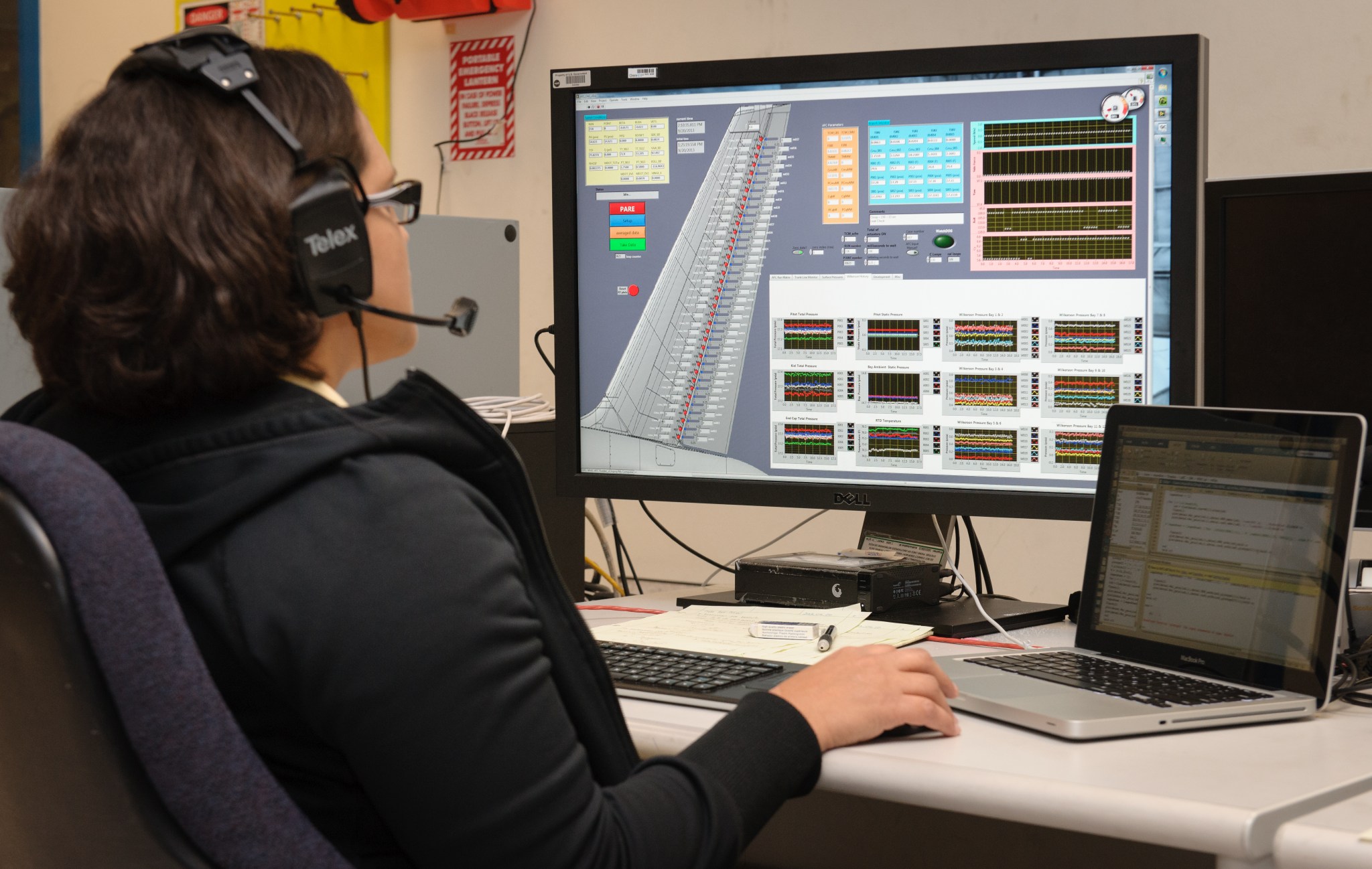 A person looking at a computer monitor analyzing the data from the tail.