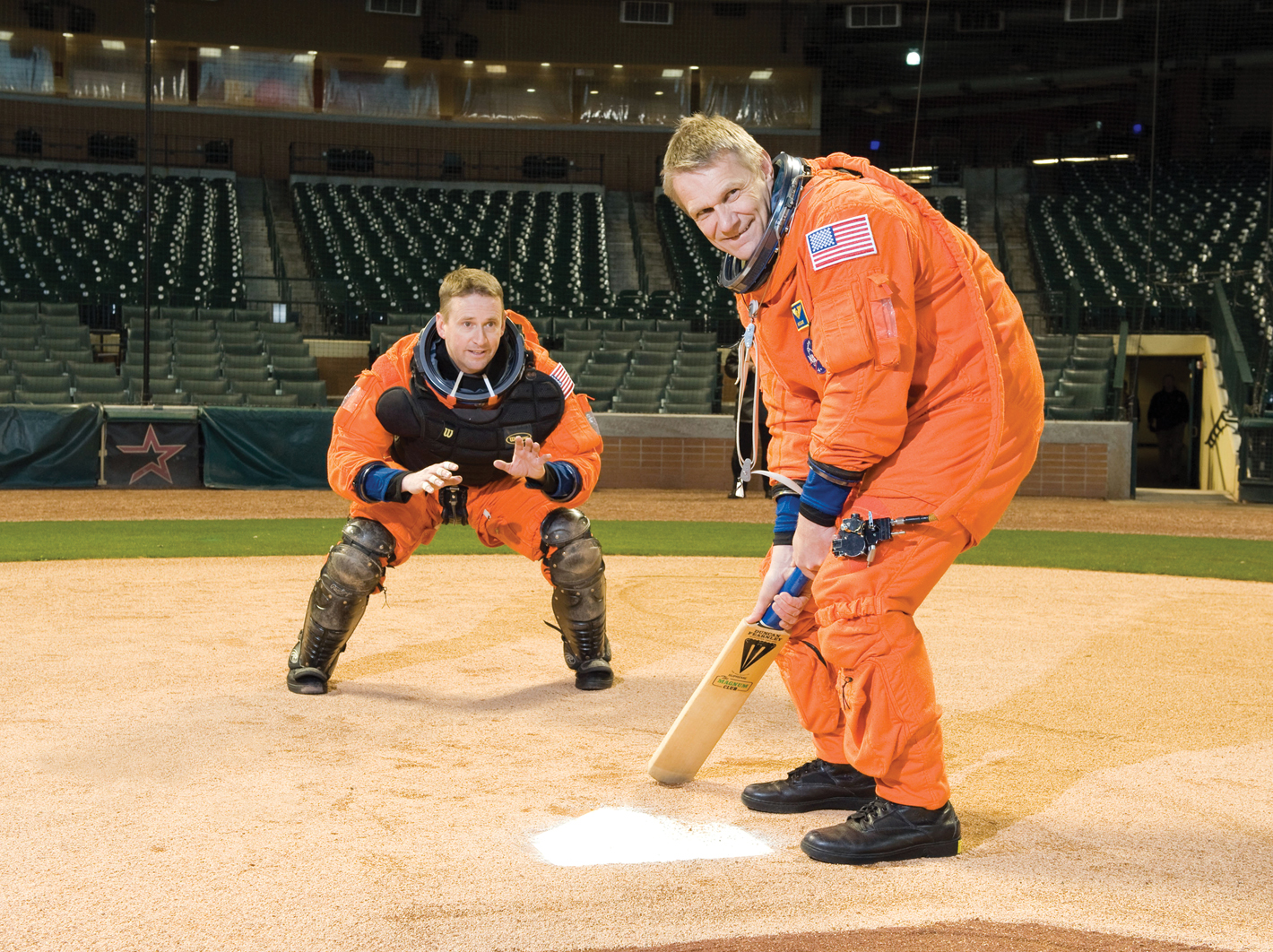 These space shuttle astronauts, taking part in a space flight awareness photo shoot playing baseball.