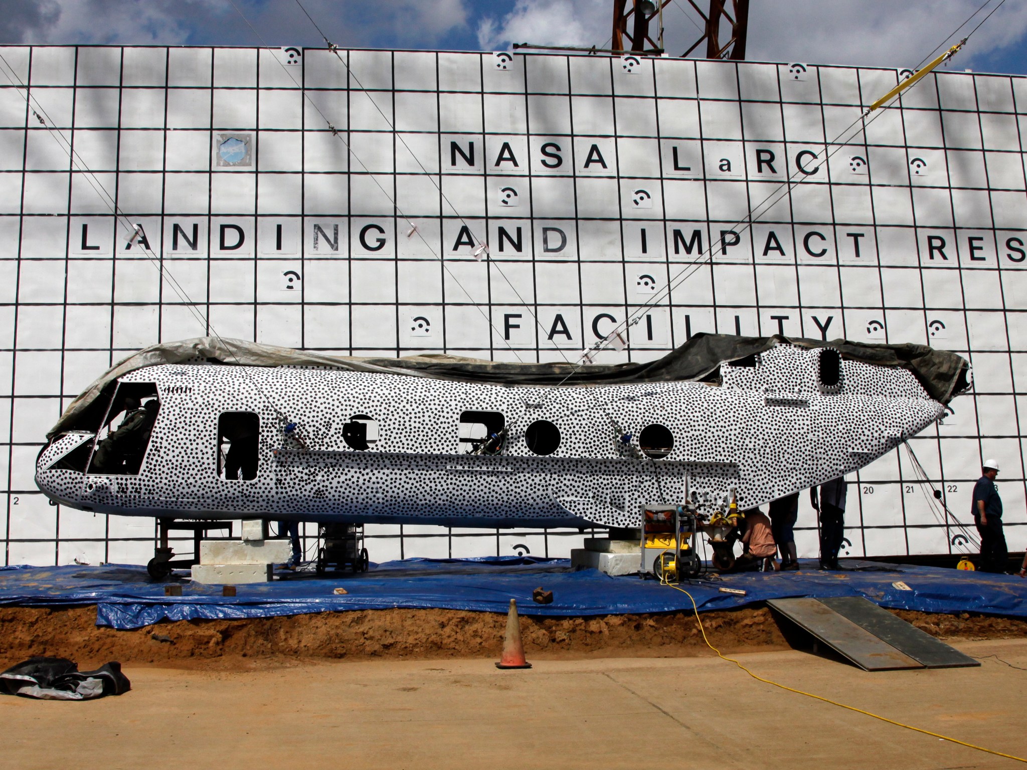 A black and white polka dot helicopter is getting prepared for a scheduled crash test.