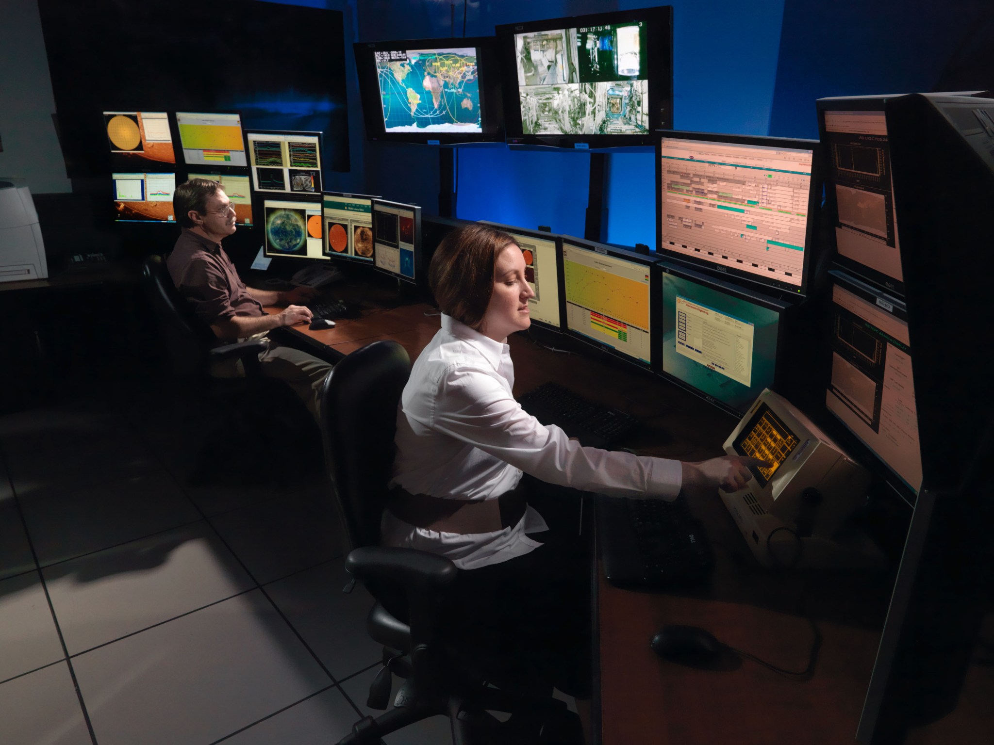 Engineers analyze radiation data in the MCC support room