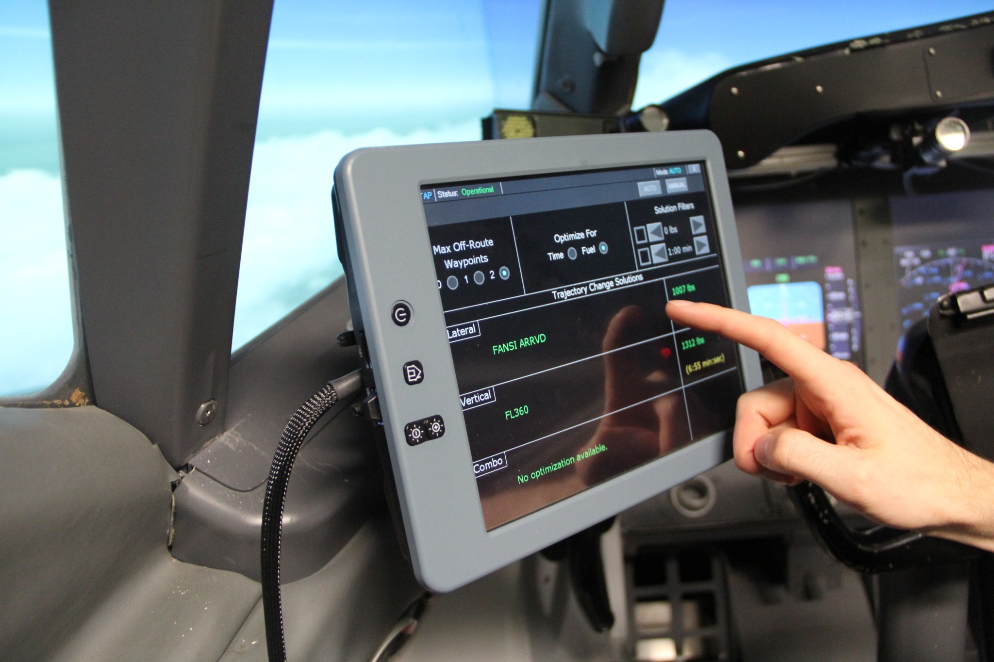 Using the Electronic Flight Bag touch screen in the cockpit of an airplane.