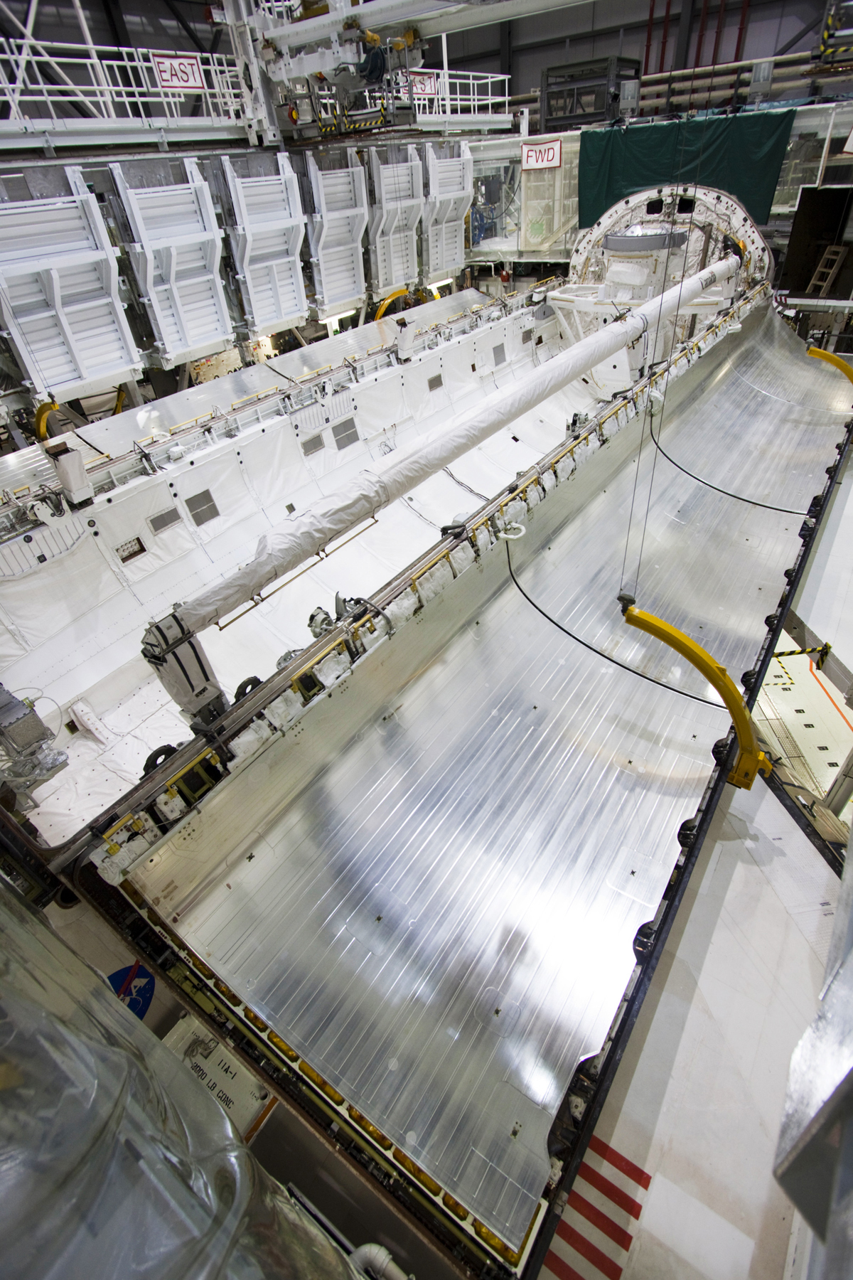 Silver payload bay doors viewed from above before closure