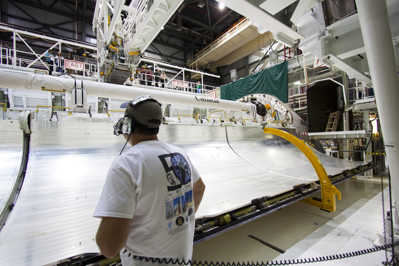 Man watches large shuttle bay door closing