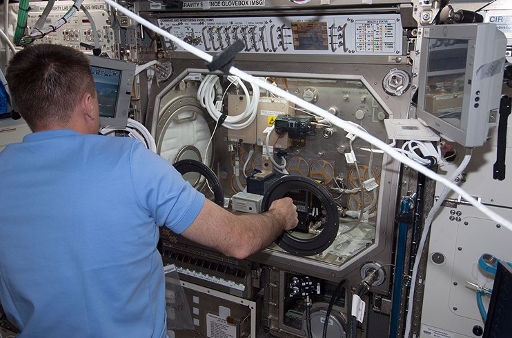 NASA astronaut Chris Cassidy conducts a session of the Burning and Suppression of Solids (BASS) investigation aboard the Interna