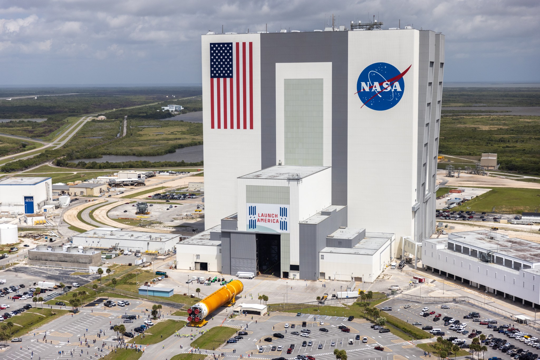 In this aerial view, teams are moving the Space Launch System core stage into the Vehicle Assembly Building at Kennedy Space Center following its arrival.