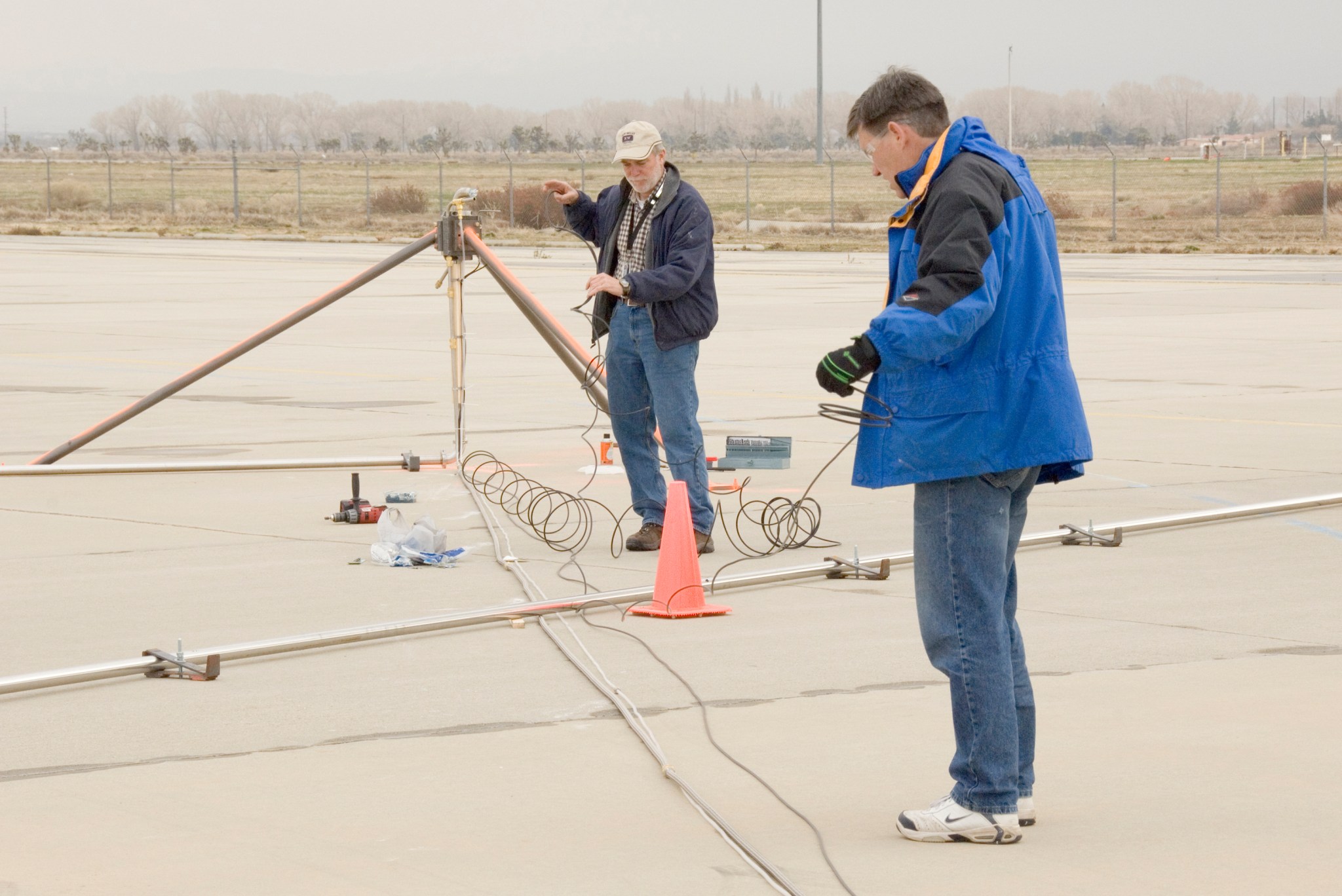 Two men installing tubing.