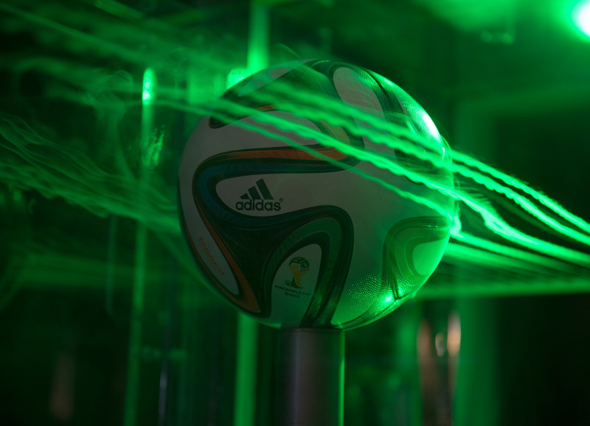Image of a soccer ball with smoke and lasers showing air flow