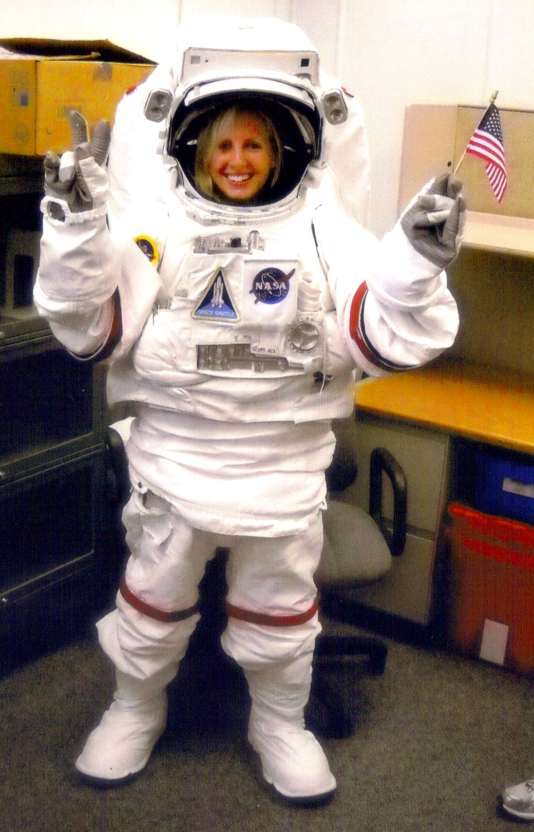 While serving as a NASA Co-op student at the Kennedy Space Center in 2009, Annie Caraccio had an opportunity to try on a replica extravehicular mobility unit, the pressure suit used by astronauts during spacewalks.