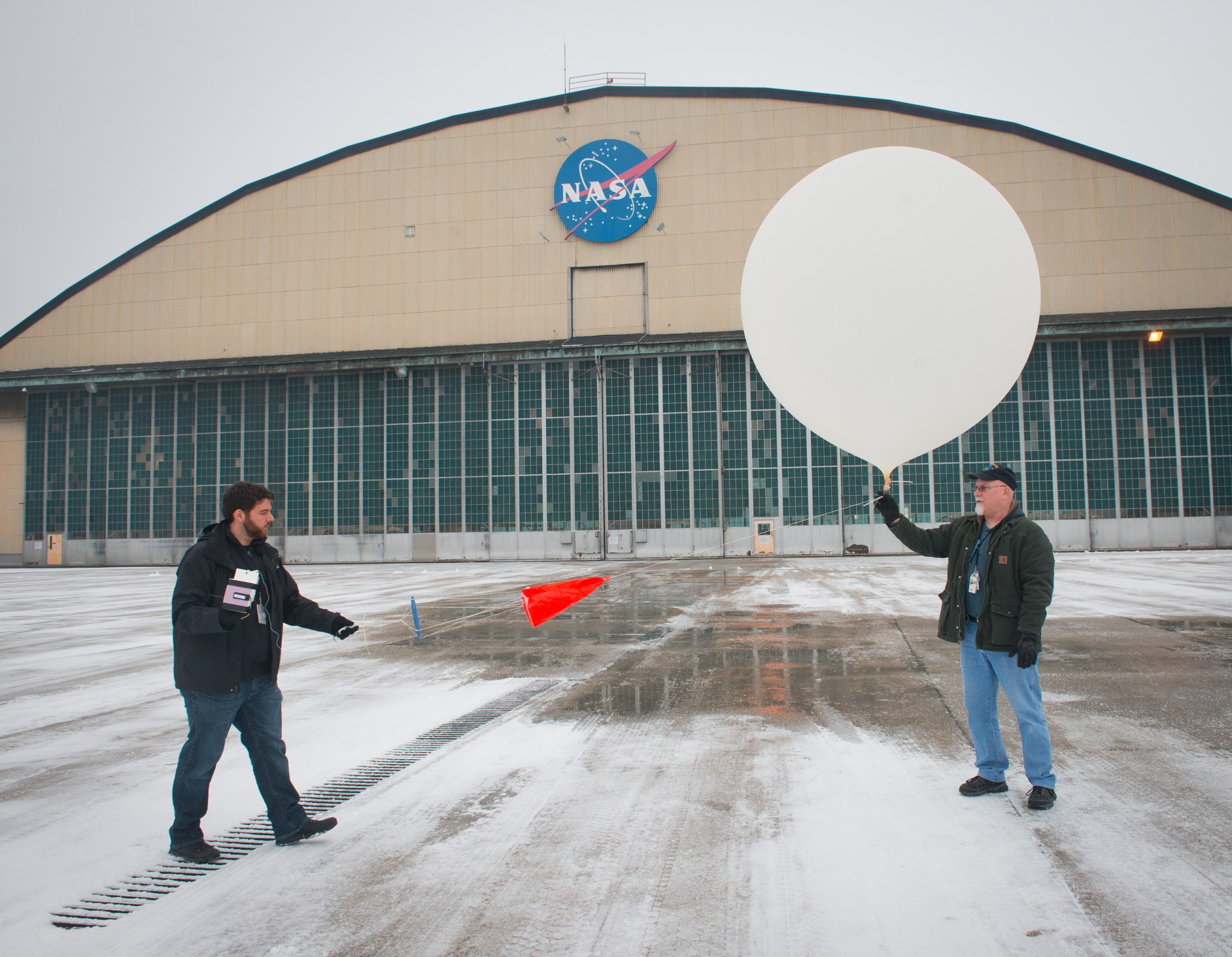NASA Glenn researcher Michael King (left) and assistant Dan Gorman launch a weather balloon